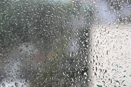 On a summer raining day. Drops of water on the window. Shallow DOFの写真素材