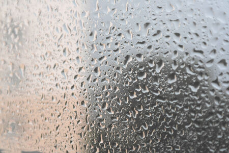 On a summer raining day. Drops of water on the window. Shallow DOFの写真素材