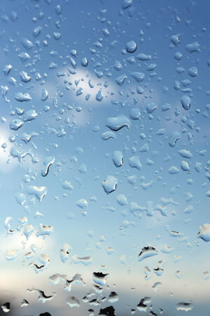 Abstract background, water drops on a window glass, rainy dayの写真素材