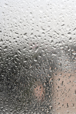 On a summer raining day. Drops of water on the window. Shallow DOFの写真素材