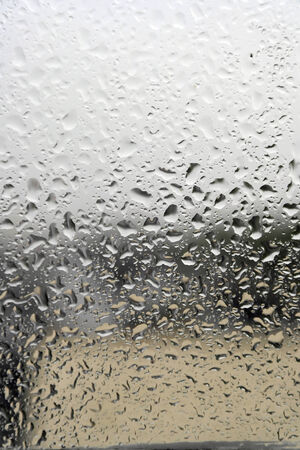 On a summer raining day. Drops of water on the window. Shallow DOFの写真素材