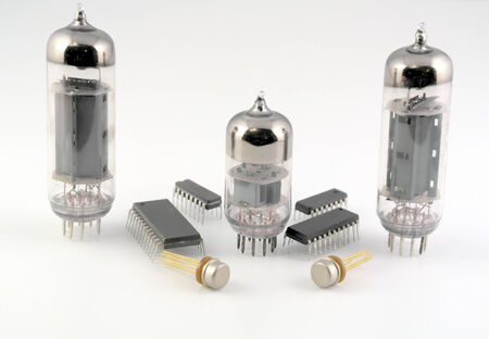 Vacuum radio tubes and semiconductor chips over whiteの写真素材