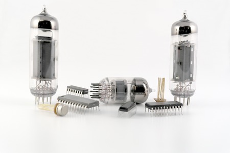 Vacuum radio tubes and semiconductor chips over whiteの写真素材