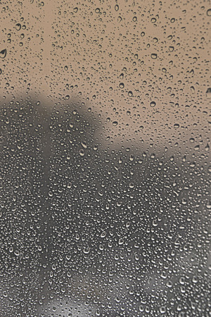 Drops of rain on the inclined window (glass). Shallow DOFの写真素材