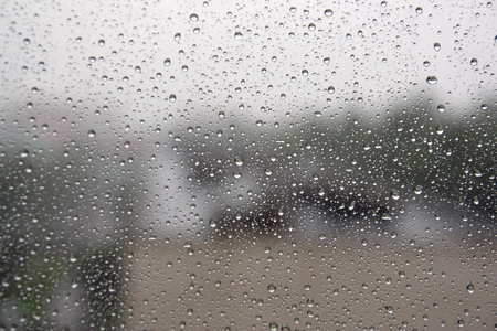 Drops of rain on the inclined window (glass). Shallow DOFの写真素材