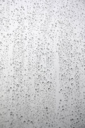 Drops of rain on the inclined window (glass). Shallow DOFの写真素材