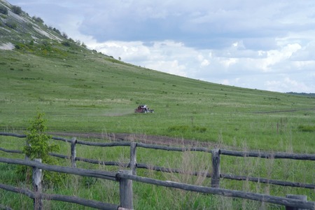 Rural summer landscape with car in fieldの写真素材