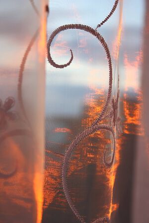 Abstract background with tulle over sunset and sky, shallow dofの写真素材