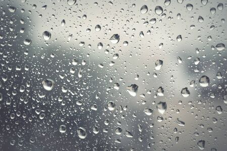 Drops of rain on the window, rainy day. Shallow DOFの写真素材