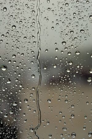 Drops of rain on the window, rainy day. Shallow DOFの写真素材