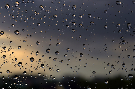 Drops of rain on the window, rainy day, dark tone. Shallow DOFの写真素材