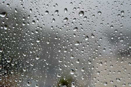 Drops of rain on the window, rainy day.の写真素材