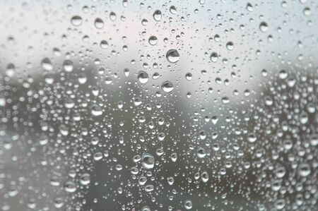 Drops of rain on the window, rainy day. Shallow DOFの写真素材