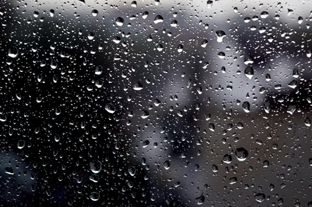 Drops of rain on the window, rainy day, dark tone. Shallow DOFの写真素材