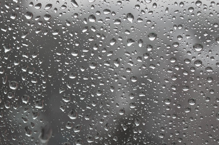 Drops of rain on the window, rainy day. Shallow DOFの写真素材