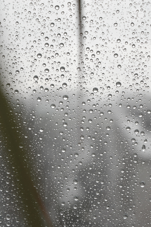 Drops of rain on the window, rainy day. Shallow DOFの写真素材