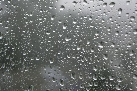 Drops of rain on the window, rainy day. Shallow DOFの写真素材
