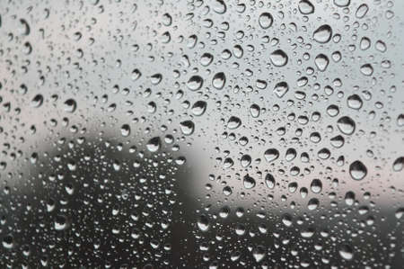 Drops of rain on the window, rainy day. Shallow DOF