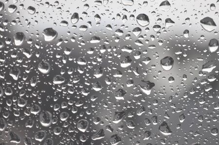 Drops of rain on the window, rainy day. Shallow DOFの写真素材