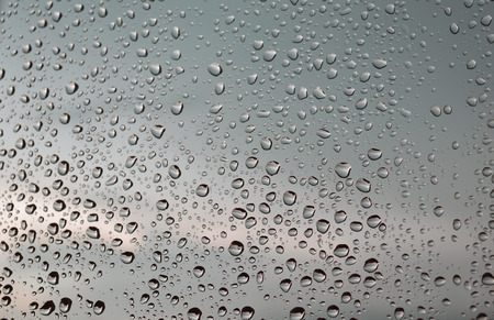 Drops of rain on the window, rainy day. Shallow DOFの写真素材