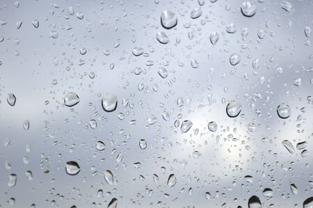 Drops of rain on the window, rainy day. Shallow DOFの写真素材