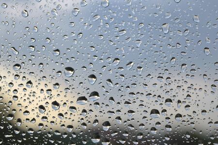 Drops of rain on the window, rainy day. Shallow DOFの写真素材