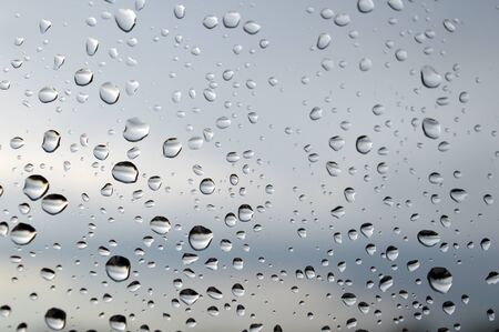 Drops of rain on the window, rainy day. Shallow DOFの写真素材