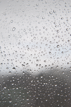 Drops of rain on the window, rainy day. Shallow DOFの写真素材