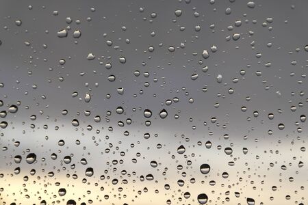 Drops of rain on the window, rainy day. Shallow DOFの写真素材