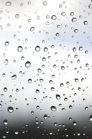 Drops of rain on the window, rainy day. Shallow DOFの写真素材