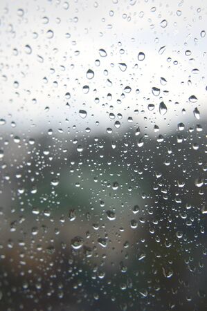 Drops of rain on the window, rainy day. Shallow DOFの写真素材