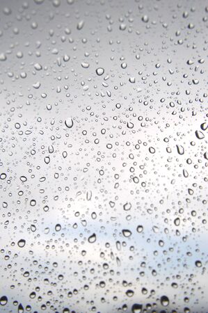 Drops of rain on the window, rainy day. Shallow DOFの写真素材
