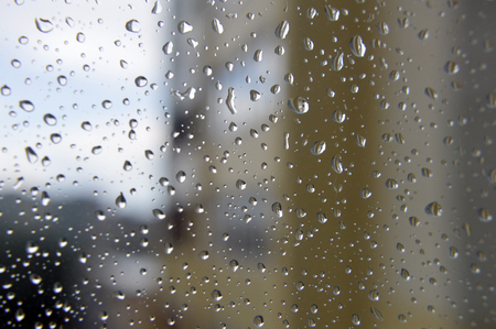 Drops of rain on the window, rainy day. Shallow DOFの写真素材