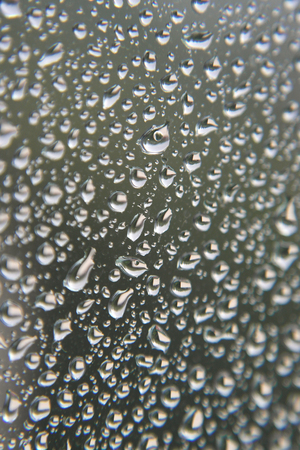 Drops of rain on the window, rainy day. Shallow DOFの写真素材