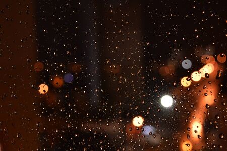 Rain drops on night window, shallow dofの写真素材
