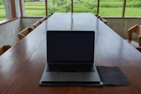 Conceptual workspace, blank space on the laptop screen in the background.
