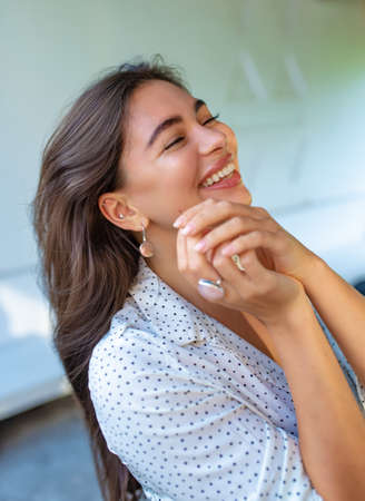 happy girl with rose quartz ring and mother of pearl earring smiling with happiness
