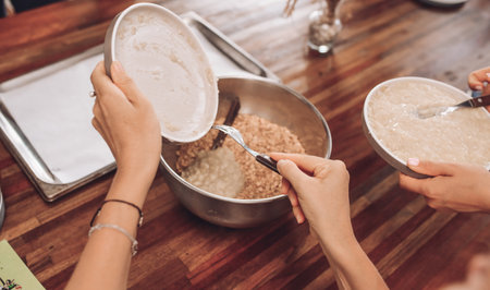 Girls bake oatmeal cookies at home. Household chores before the holidayの写真素材