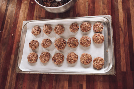 raw unbaked homemade oatmeal cookies on baking sheet flat layの写真素材