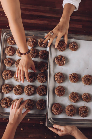 Girls bake oatmeal cookies. Women's hands. Vegan food. Home made. Top Viewの写真素材