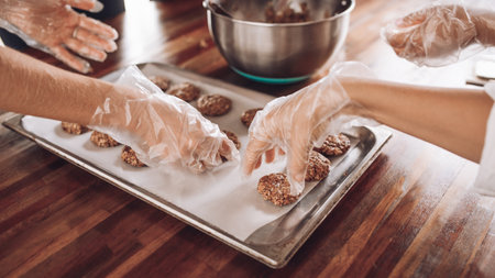 Girls bake oatmeal cookies. Women's hands. Vegan food. Home made. Raw