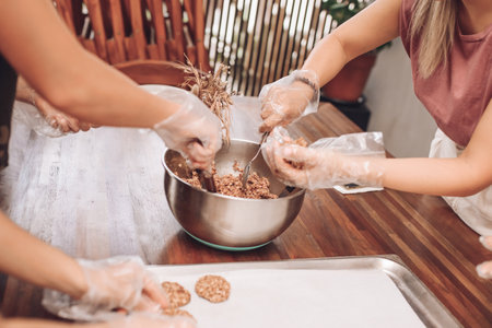 Girls bake oatmeal cookies. Women's hands. Vegan food. Home made. Rawの写真素材