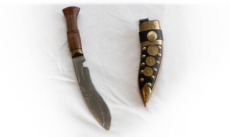 Old indian handmade knife in leather scabbard on a white background. Engraving, leather, metal, wood.の写真素材