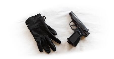 The crime. Contract kill. Killer. Black leather glove and gun on a white background. Black and white photography. Concept.の写真素材