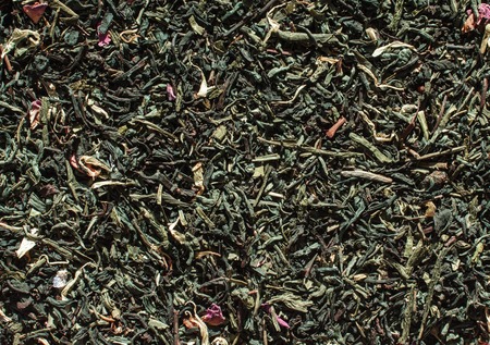 Heap of dry green tea leaves backgroundの写真素材