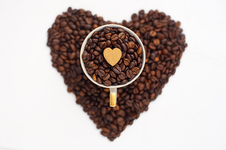 cup of coffee beans in the shape of heartの写真素材