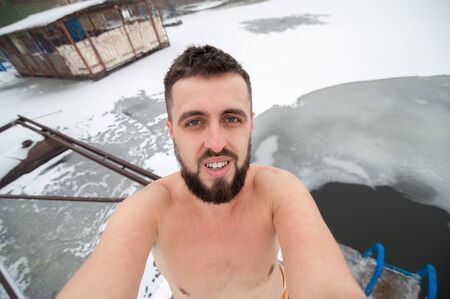 man take his journey selfie photo with wide angle camera, ice hole swimmingの写真素材