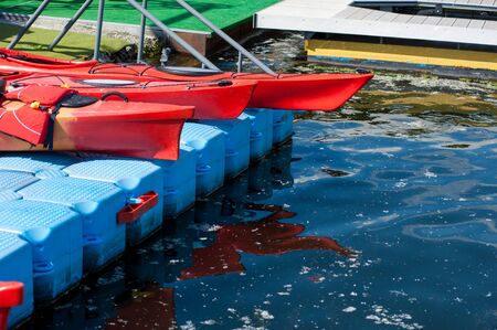 plastic kayaks on the dock, before the startの写真素材