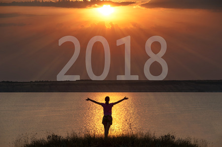  silhouette of a woman with sunrise. New Year is coming conceptの写真素材