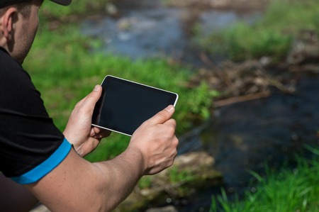 young man with laptop working outdoorsの写真素材